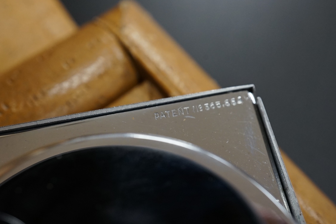A leather cased chrome LeCoultre 8-day travelling timepiece, 9.5cm wide